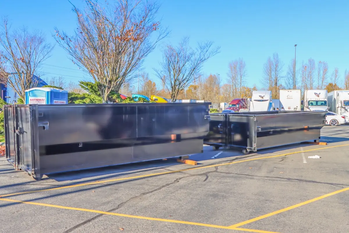 Professional dumpster rental service with roll-off container on residential driveway in Gorham